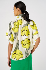 Profile view of model wearing the Oroton Golden Tulip Blouse in Lemon Curd and 100% silk for Women