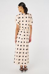 Profile view of model wearing the Oroton Large Spot Print Dress in Soft Peach and 100% Silk for Women