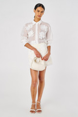 Profile view of model wearing the Oroton Lace Flower Sheer Overshirt in Antique White and 100% Cotton for Women