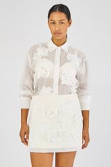 Profile view of model wearing the Oroton Lace Flower Sheer Overshirt in Antique White and 100% Cotton for Women