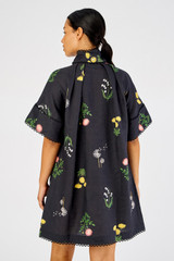 Profile view of model wearing the Oroton Dandelion Smock Dress in Black and 100% linen for Women