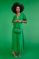 Profile view of model wearing the Oroton Cape Sleeve Dress in Jewel Green and 93% silk 7% spandex for Women